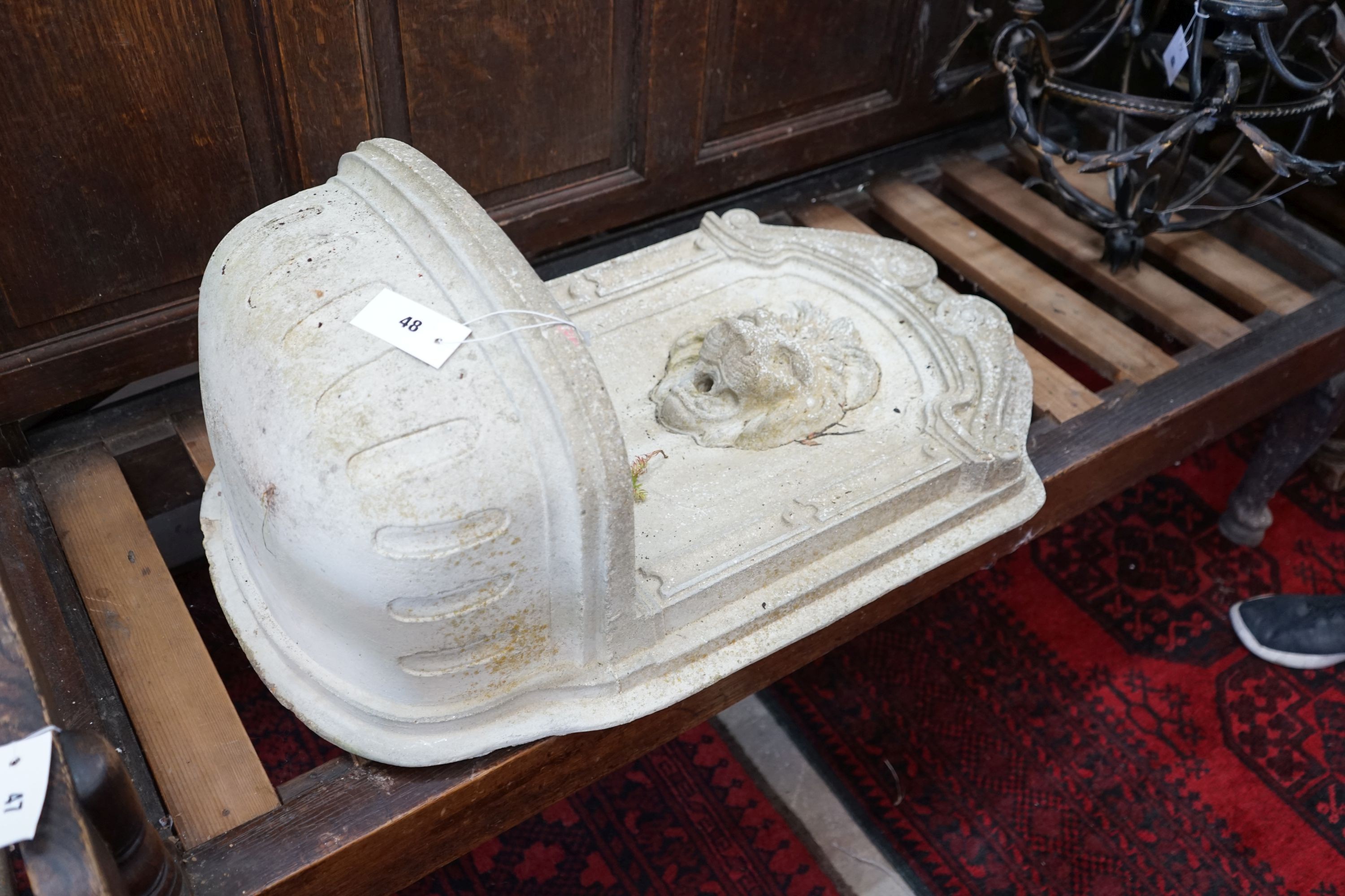 A reconstituted stone garden fountain with lion mask spout, height 75cm